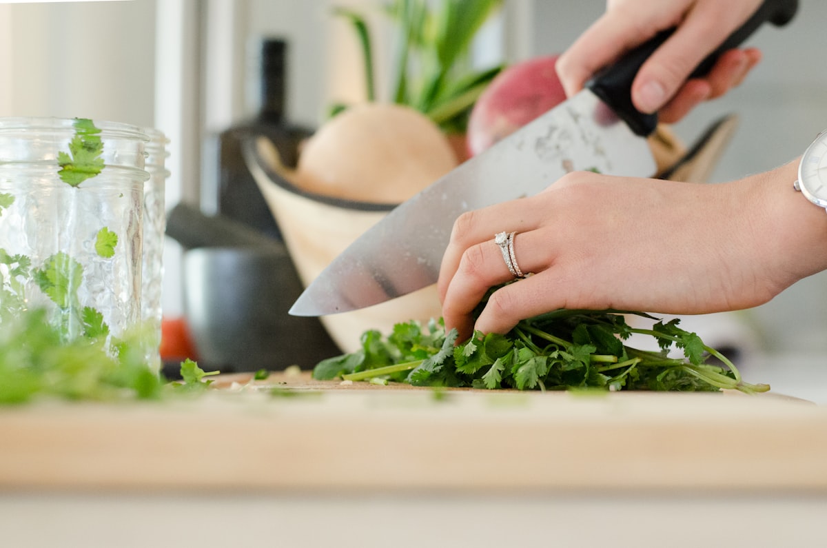 Hands preparing fresh organic vegetables with traditional cooking methods